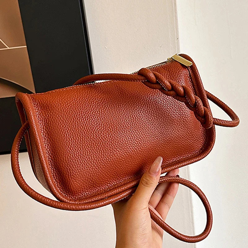 Genuine cowhide leather women's crossbody handbag with high capacity, stylish shoulder bag for ladies, featuring a sleek design.