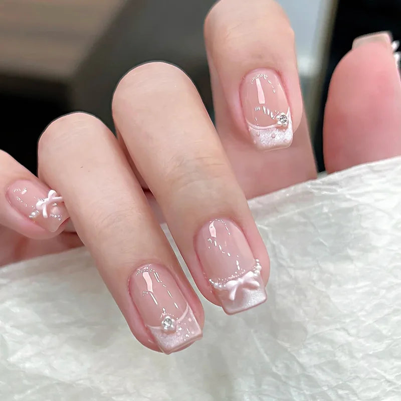 24-piece cute girly short square false nails with white French tips, glitter stars, rhinestones, cat-eye, and bow art
