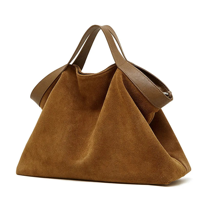 Genuine leather women's handbag with large capacity, shoulder strap, and crossbody style in black, featuring stylish cowhide design.