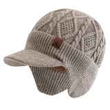 Unisex winter hat with plush fur lining, warm earflaps, and thick knitted beanie design for skiing and outdoor wear