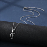 Simple stainless steel initial letter pendant necklace for women, featuring a glossy finish on a delicate clavicle chain jewelry piece.