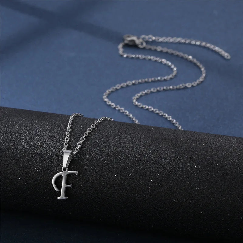 Simple stainless steel initial letter pendant necklace for women, featuring a glossy finish on a delicate clavicle chain jewelry piece.