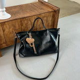 Luxury PU leather women's handbag with spacious design, shoulder strap, and stylish tote for commuting or office use.