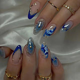24-piece Y2K star press-on false nails with gradient blue French tips and gold moon designs, almond shape