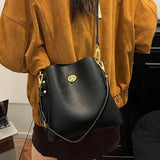 Elegant burgundy PU leather women's handbag with large capacity, bucket style, shoulder strap, and versatile tote design.