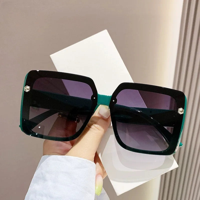 Vintage women's square sunglasses with large frame and retro style, showcasing black plastic shades from HSF Marketplace.