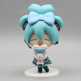 Hatsune Miku anime figurine holding a Cinnamoroll plush, kawaii tabletop collectible figure doll <|endoftext|>