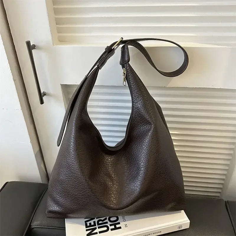 Large black leather tote bag for women with shoulder strap, spacious interior, and simple elegant design from HSF Marketplace.