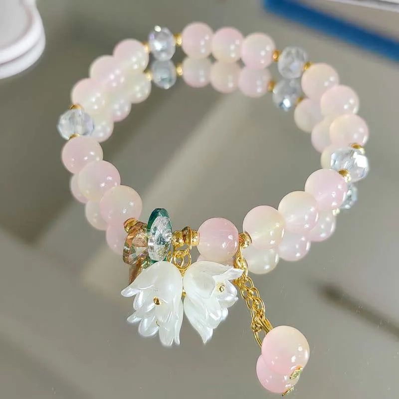 Colorful Lily Valley flower bracelet for women with crystal bead accents, elastic design, perfect for wedding or birthday jewelry.