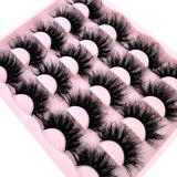 Set of 10 pairs of 25mm wispy faux mink eyelashes with thick, dramatic, and fluffy volume for a bold cat eye makeup look.
