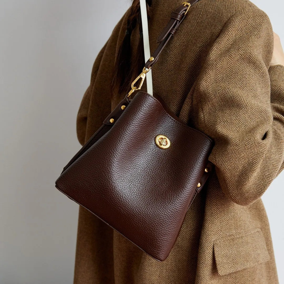 Elegant burgundy PU leather women's handbag with large capacity, bucket style, shoulder strap, and purse features.