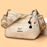 Women's vintage leather crossbody purse with multiple pockets and ethnic pattern strap, perfect for everyday use.