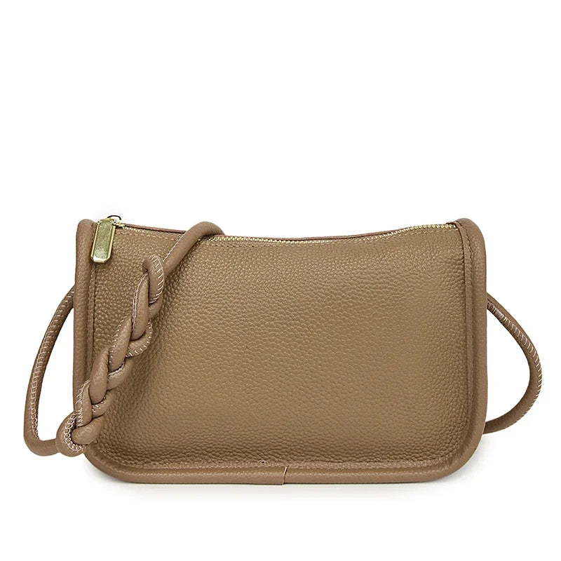 Genuine cowhide leather crossbody handbag for women, high-capacity shoulder bag with stylish design and spacious interior.