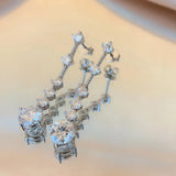 Moissanite dangle earrings with 3ct VVS1 stones, silver tassel design by HSF Marketplace