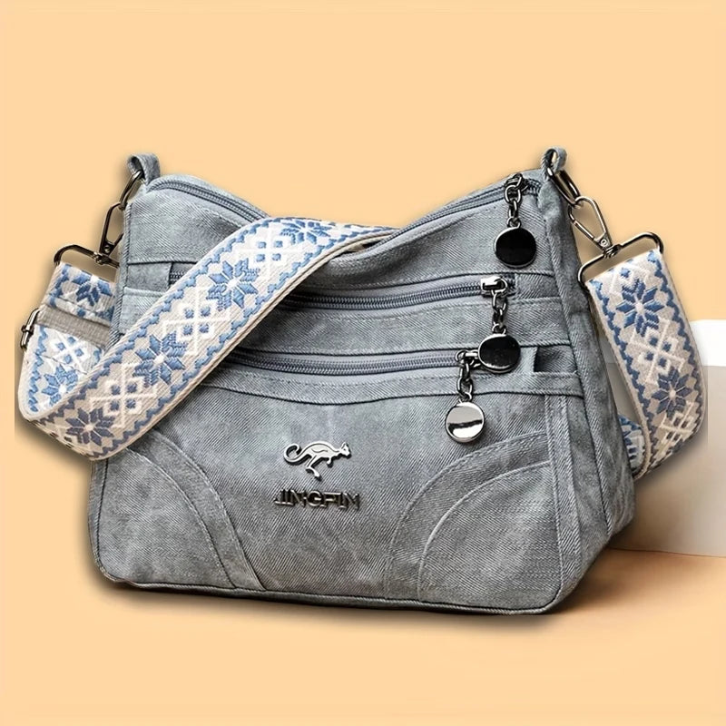 Spacious women's vintage leather shoulder purse with multi-pocket design and ethnic patterned strap, ideal for everyday use.