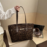 Leopard print shoulder tote bag with faux leather trim, gold lock detail, spacious design, ideal for women’s work and daily use.