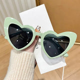 Pink heart-shaped vintage sunglasses by HSF Marketplace with transparent shiny lenses, perfect for beach parties and photo fashion.