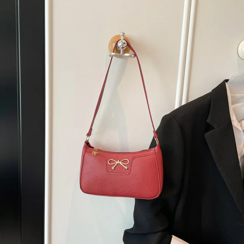 Ladies bow design underarm shoulder handbag by HSF Marketplace, stylish and functional purse for everyday commute.