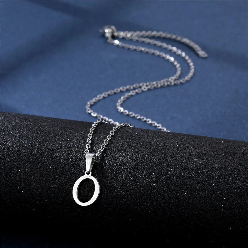 Glossy stainless steel initial letter pendant necklace for women, simple choker chain jewelry with a modern design.