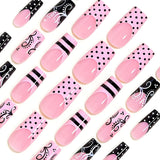 24-piece Sweet Punk pink and black French press-on nails with polka dot stripes, long coffin false nail tips
