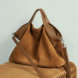 Genuine leather women's handbag with large capacity, shoulder and crossbody styles, featuring cowhide material and spacious tote design.
