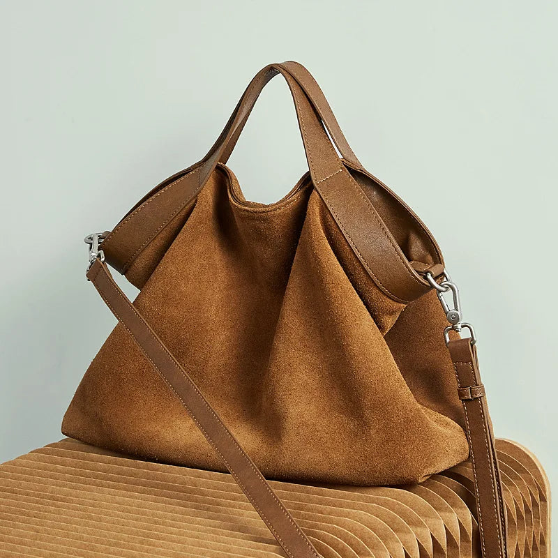 Genuine leather women's handbag with large capacity, shoulder and crossbody styles, featuring cowhide material and spacious tote design.