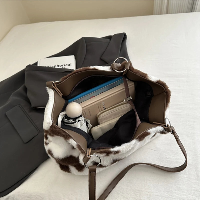 Large women's winter tote bag with cow print plush shoulder design, spacious travel shopper handbag by HSF Marketplace.