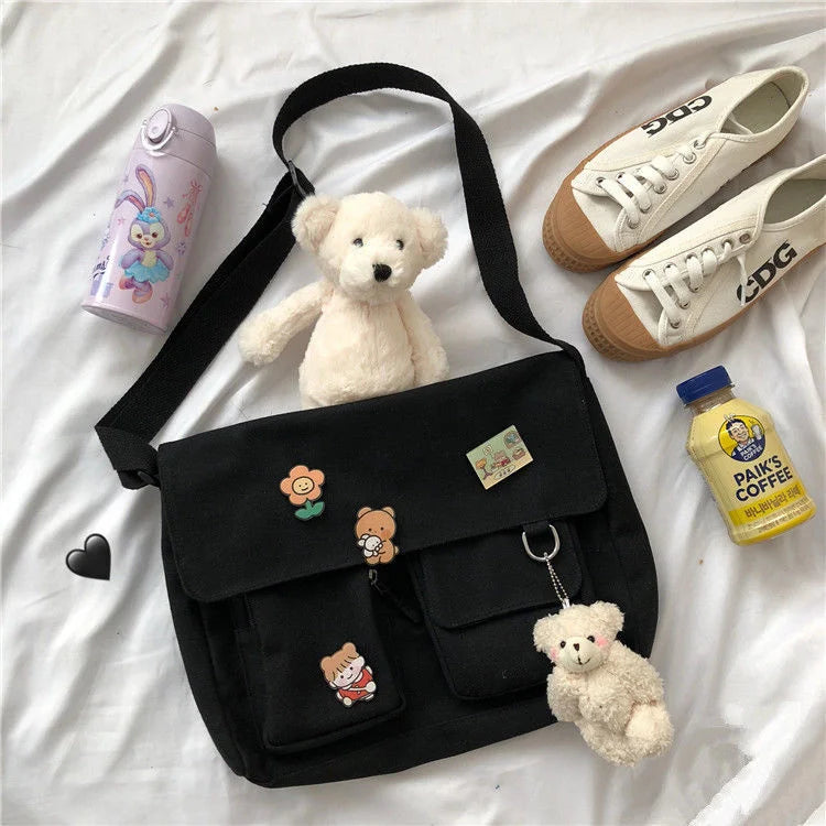 Casual women's canvas messenger bag with printed design, shoulder strap, and pouch, ideal for school or everyday use.