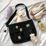 Casual women's canvas messenger bag with printed design, shoulder strap, and pouch, ideal for school or everyday use.