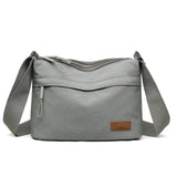 Canvas shoulder crossbody bag for women with three main pockets, high capacity purse, suitable for moms and shopping.
