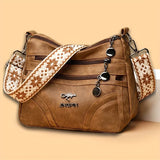 Women's vintage leather shoulder purse with multi-pocket design, ethnic pattern strap, ideal for everyday use.