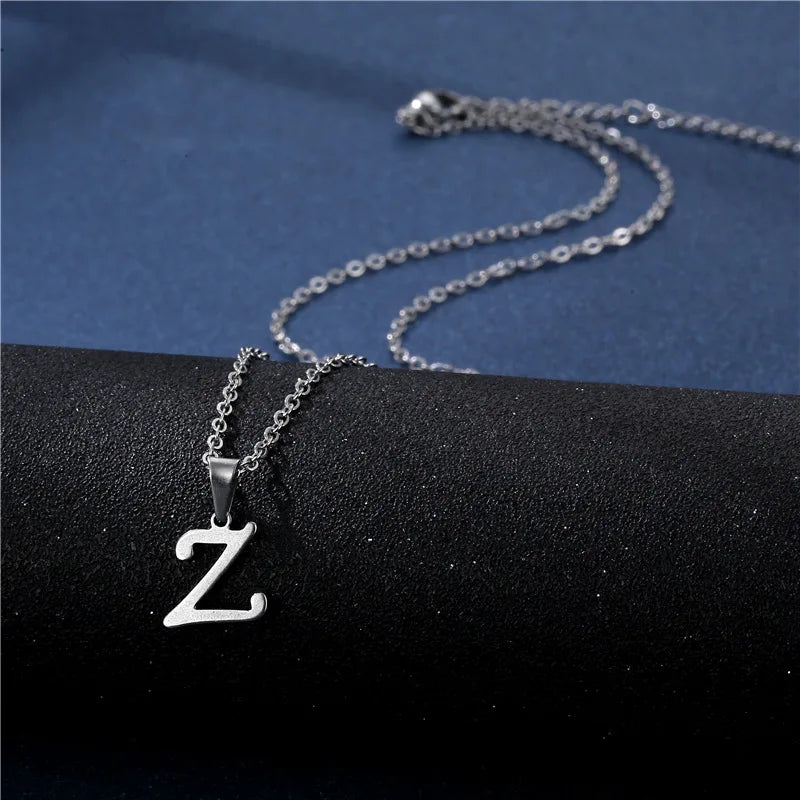 Simple stainless steel initial letter pendant necklace for women, featuring a glossy chain choker and elegant jewelry design.