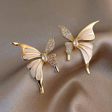 Cute butterfly stud earrings with white enamel crystal wings and golden color metal, for women