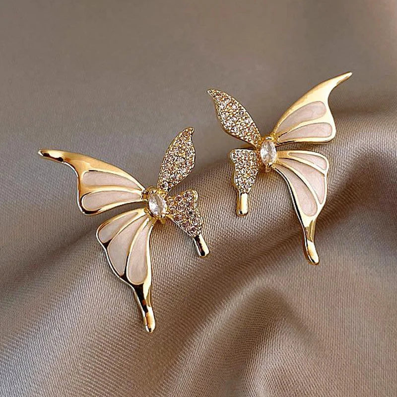 Cute butterfly stud earrings with white enamel crystal wings and golden color metal, for women