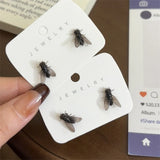 Realistic fly stud earrings for women, small black insect design by HSF Marketplace