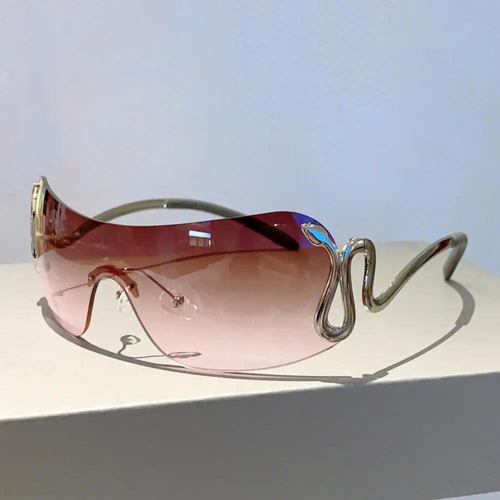 Y2K rimless sunglasses for women with snake ray design, metal legs, gradient lenses, wrap-around style, luxury punk eyewear.