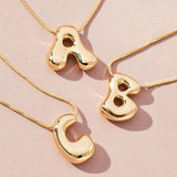 Golden stainless steel initial necklace for women and girls featuring chunky bubble letter pendant, trendy collar jewelry.