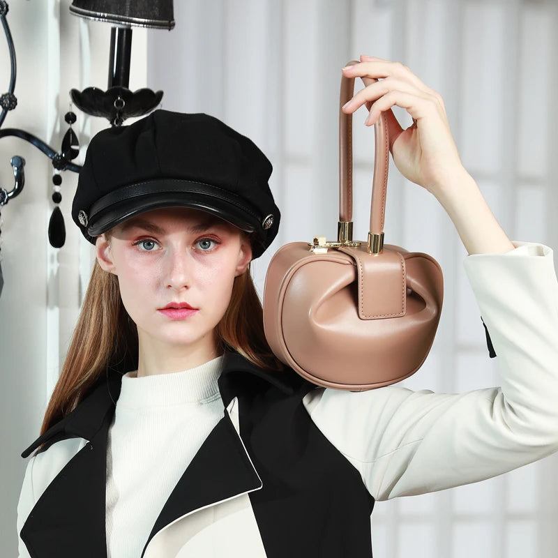 HIFASHION small genuine leather evening bag with top handle, round shape, elegant design, perfect for parties and special occasions.