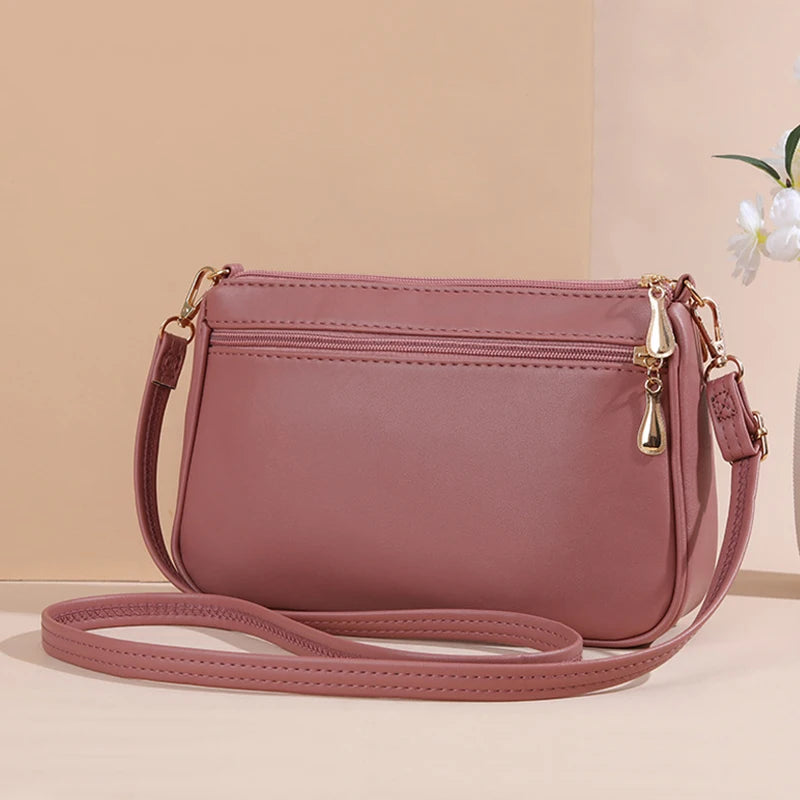 PU leather crossbody handbag for women with zipper, embroidery detail, large capacity, stylish shoulder bag, compact purse and handbag.