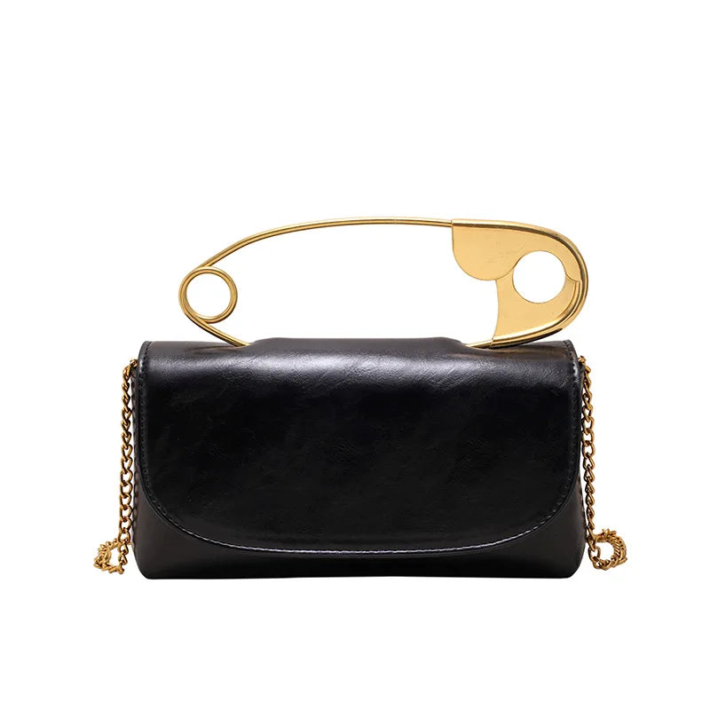Red retro metal pin design women’s crossbody bag with PU leather, chain sling, clutch style, by HSF Marketplace.