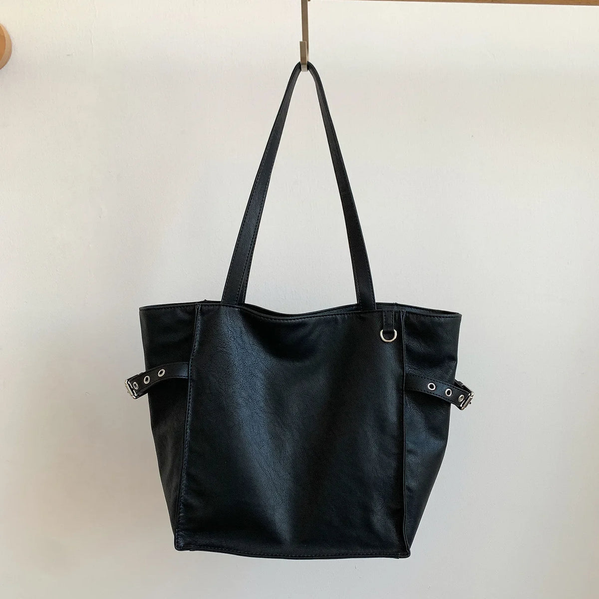 Black Rivet Design women's shoulder handbag with large capacity, elegant office style, featuring brand details and spacious tote design.