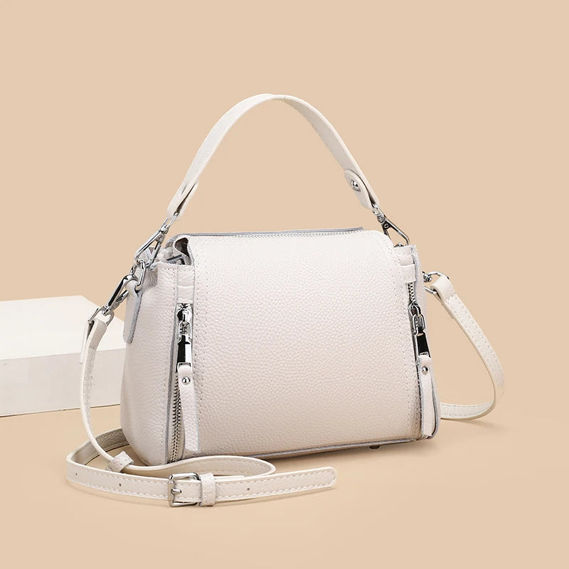 Genuine leather designer women's messenger bag with high capacity, crossbody style, and shoulder strap, in luxurious cowhide design.