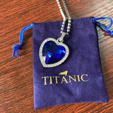 HSF Marketplace Titanic Heart of Ocean blue pendant necklace featuring a heart-shaped love design, displayed with a velvet bag.