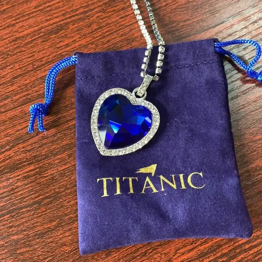 HSF Marketplace Titanic Heart of Ocean blue pendant necklace featuring a heart-shaped love design, displayed with a velvet bag.