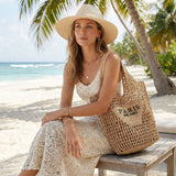 Handmade woven straw beach tote bag for women with mesh hollow shoulder design, perfect for summer holidays.