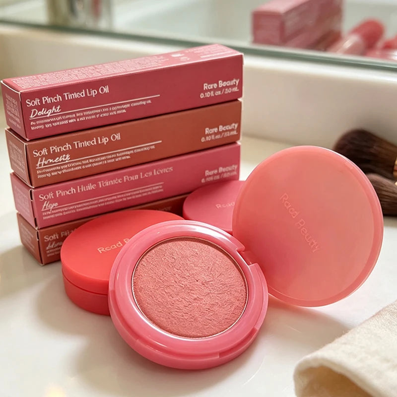 Close-up of HSF Marketplace matte lipstick and natural powder blusher, showcasing smooth application and portable makeup products.