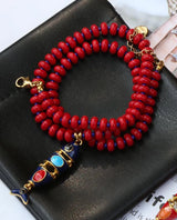 Red and blue beaded necklace with multi-layer fish pendant, stainless steel accents, and natural stone beads by HSF Marketplace.