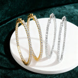 Moissanite hoop earrings in sterling silver for women, featuring sparkling stones encircling the hoops