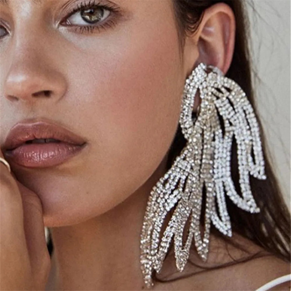 Oversized rhinestone wing drop earrings by HSF Marketplace, featuring sparkling crystal embellishments and a dramatic design