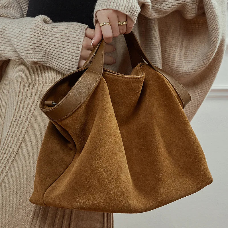 Large capacity genuine leather women's handbag with shoulder and crossbody straps, stylish cowhide tote for commuting.